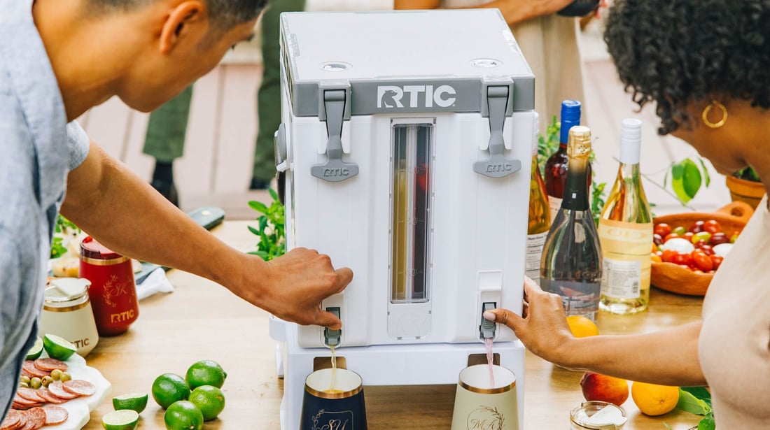 Couple dispensing drinks from the Double-Time Water Cooler