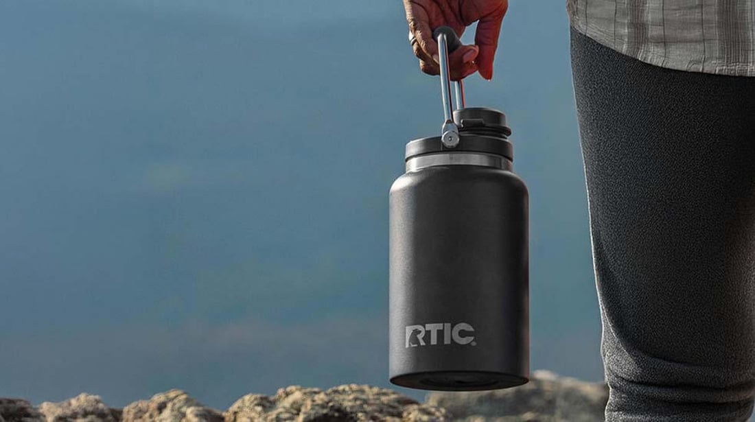 Person holding a black RTIC outback jug