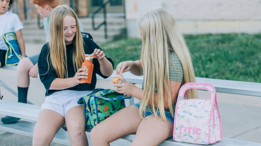 Two children open the RTIC Ice Lunch Bag.