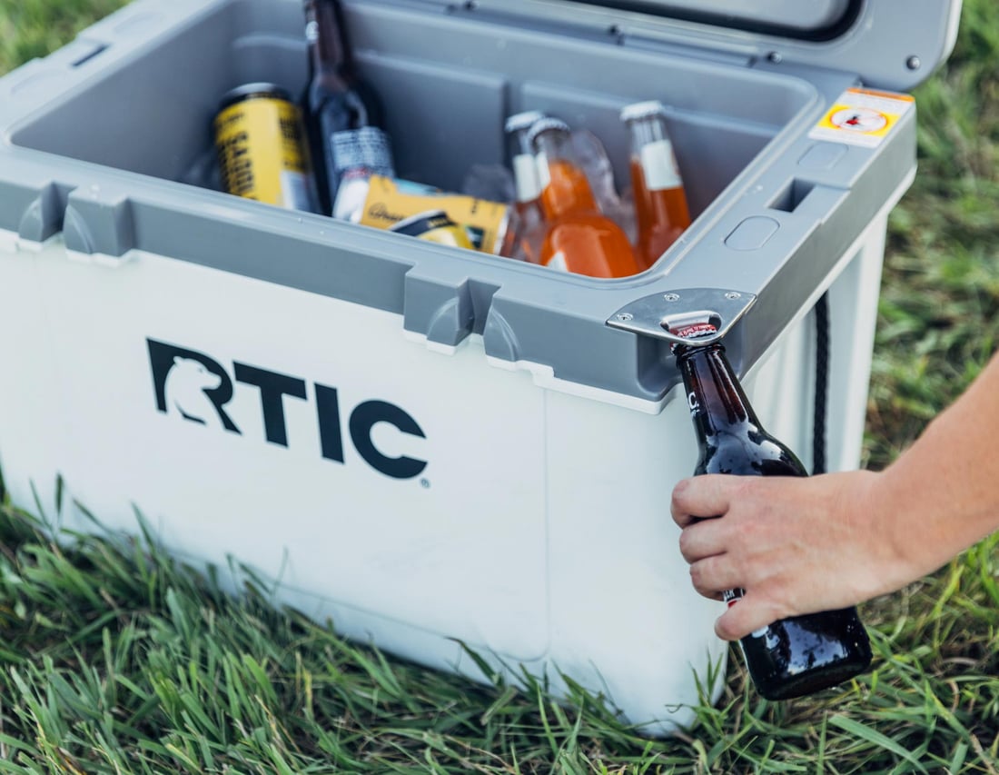 Bottle opener being used on the RTIC 32QT Ultra-Light Cooler