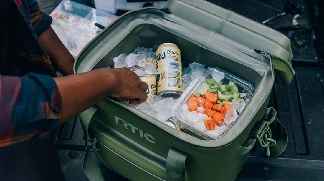 Green RTIC Ultra-Tough Soft Cooler Pro filled with ice, food and drinks