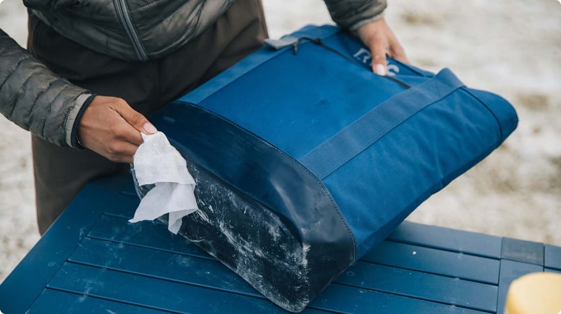 Man cleaning RTIC Insulated Slim Tote after using it