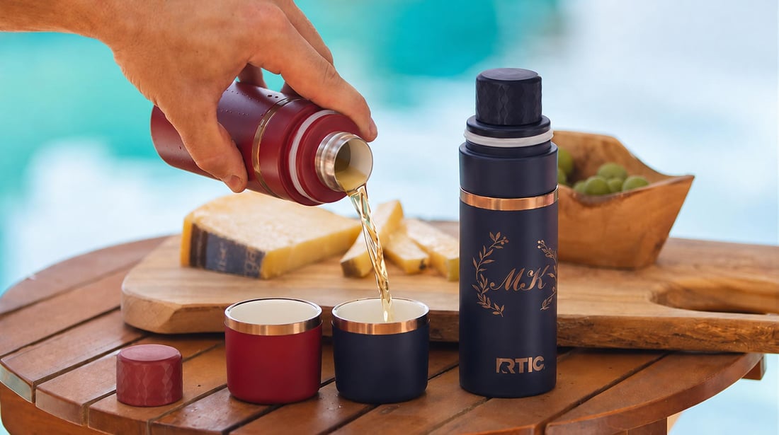 Pouring a drink by the pool from a RTIC 8oz Happy Hour Flask.