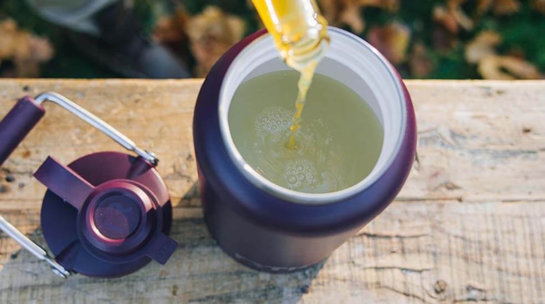 Drink being poured into a purple RTIC outback Jug