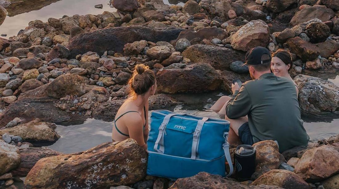 A family at the beach with a blue 2-in-1 Chillout Bag