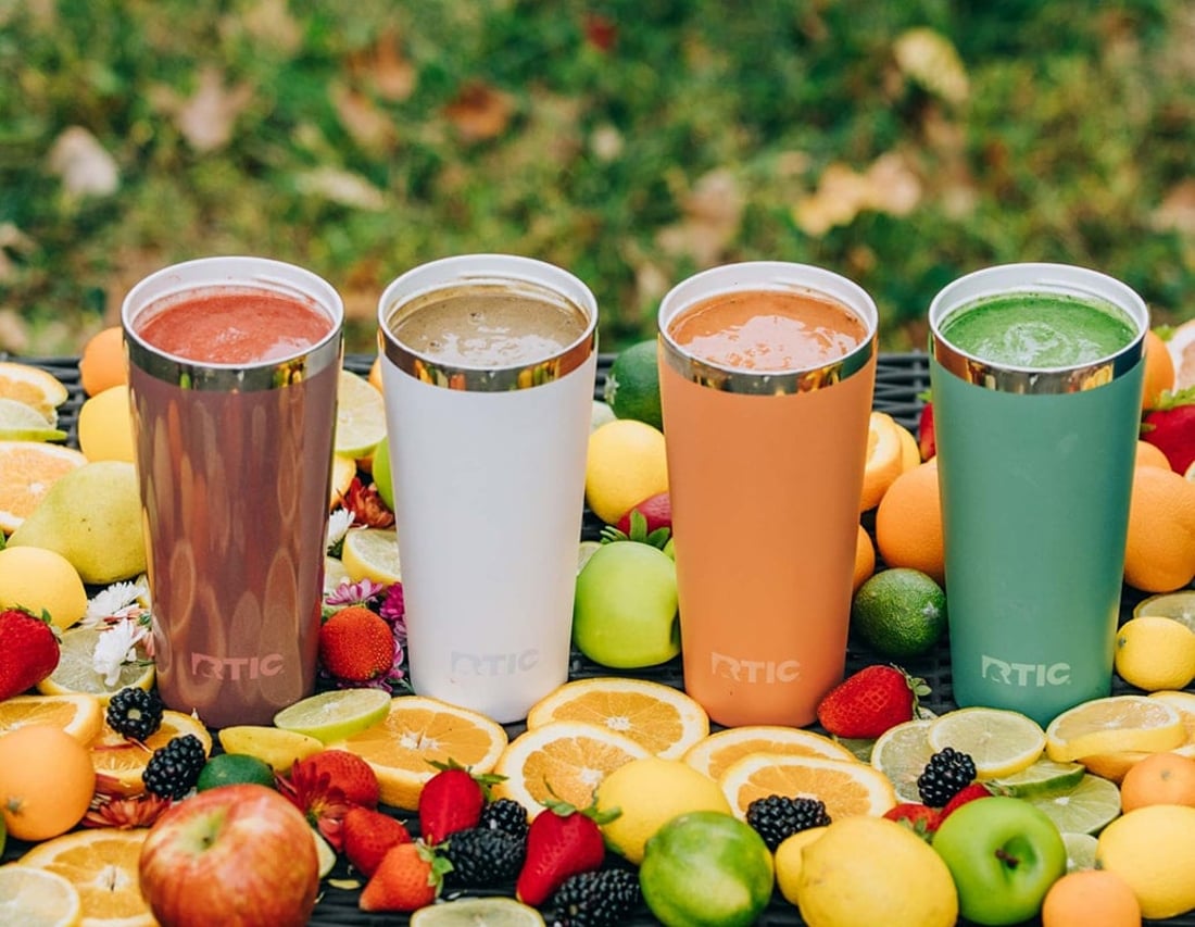 4 different colored RTIC Everyday Tumblers with fruit surrounding them