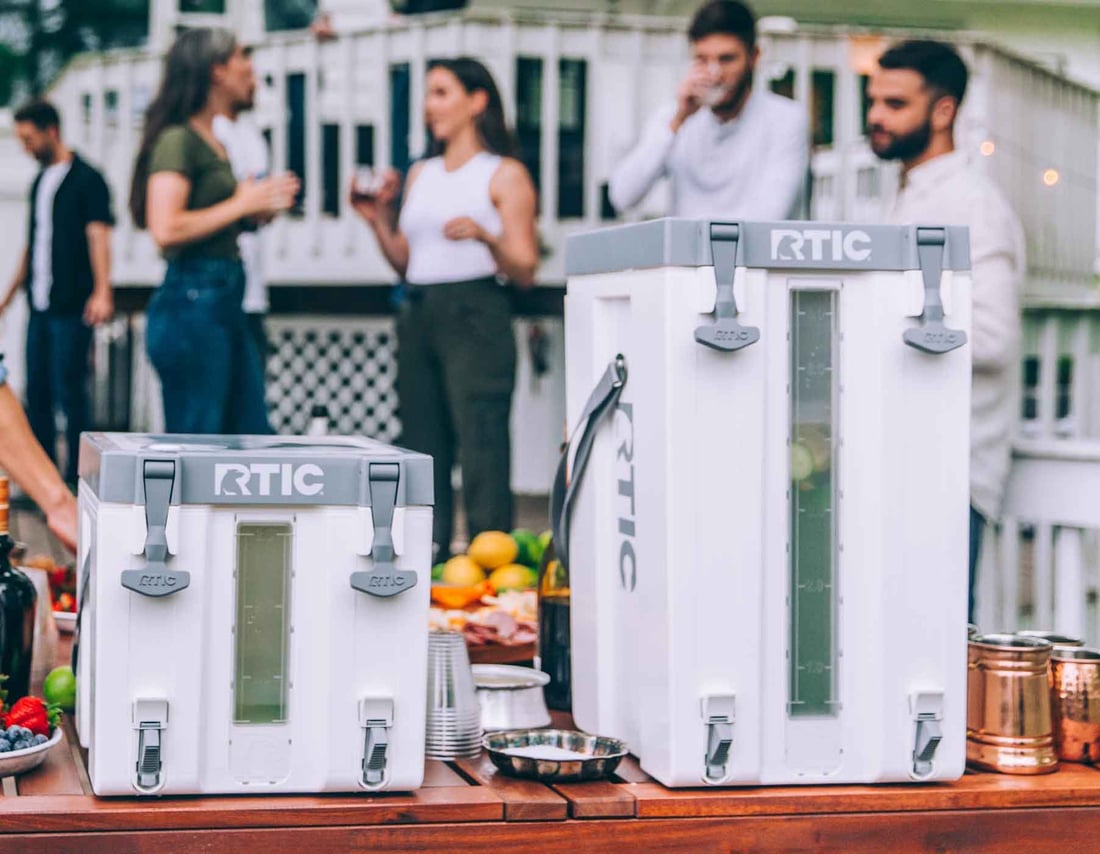 3 gallon and 6 gallon RTIC Halftime Water Coolers set next to each other on a table
