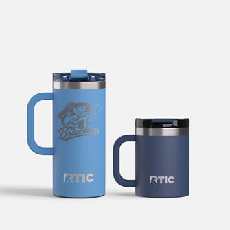 Two RTIC mugs in shades of blue on a light grey background.