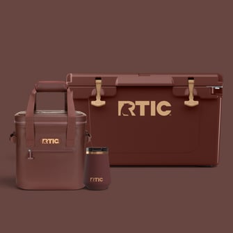 Chocolate Brown RTIC coolers and drinkware with tan accents on a brown background.