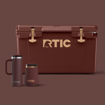 Chocolate Brown RTIC coolers and drinkware with tan accents on a brown background.