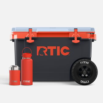Orange RTIC drinkware and a dark grey cooler with orange accents on a light grey background.