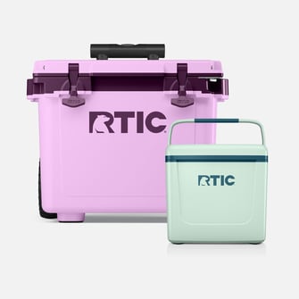 A light purple RTIC wheeled hard cooler and a small mint green RTIC hard cooler on a light grey background.
