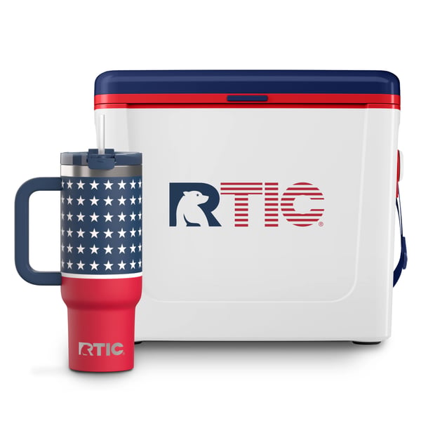 White 16 QT RTIC Road Trip Cooler with navy and red accents next to a Road Trip Tumbler with navy and red background with stars pattern.