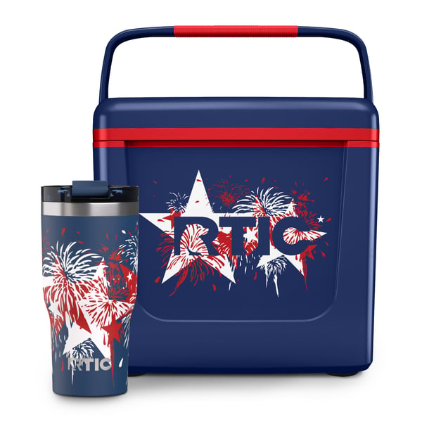 Navy RTIC 8 QT Road Trip Personal Cooler with stars and fireworks design on it, next to a navy Essential Tumbler with the same design on it.