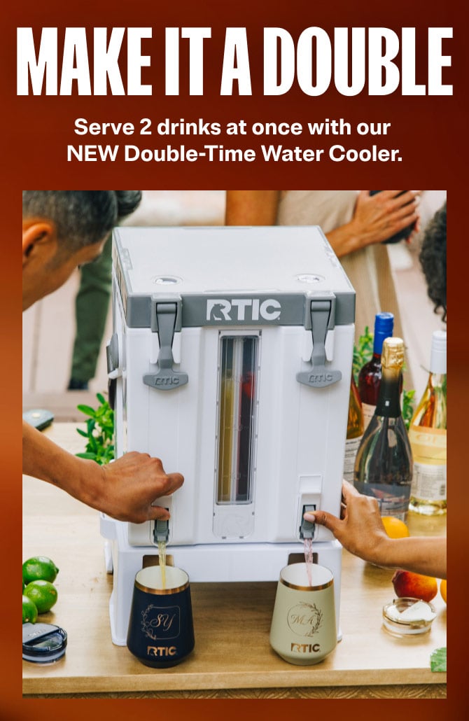 two people use an RTIC water cooler to pour drinks simultaneously, with food and beverages on a table.