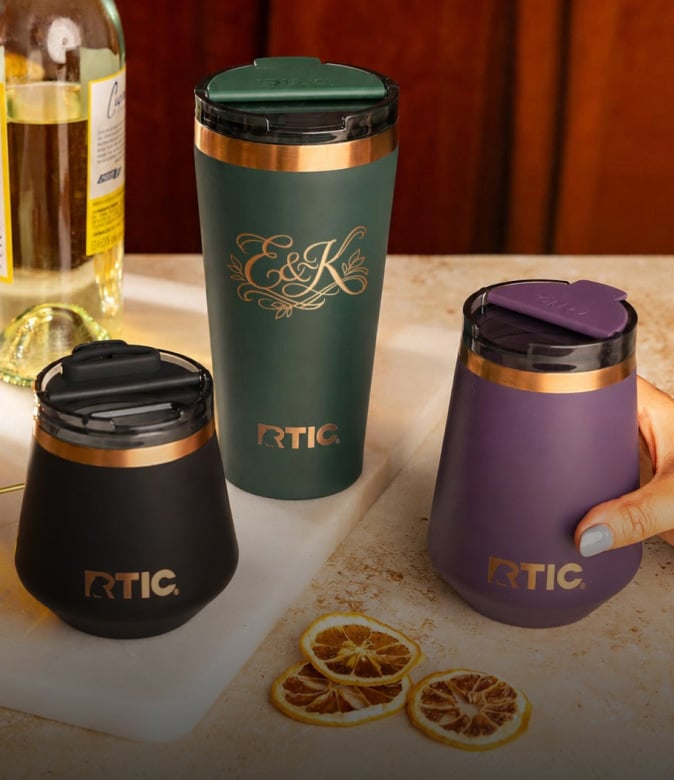 A group of RTIC Happy Hour barware in navy, dark green, and purple.