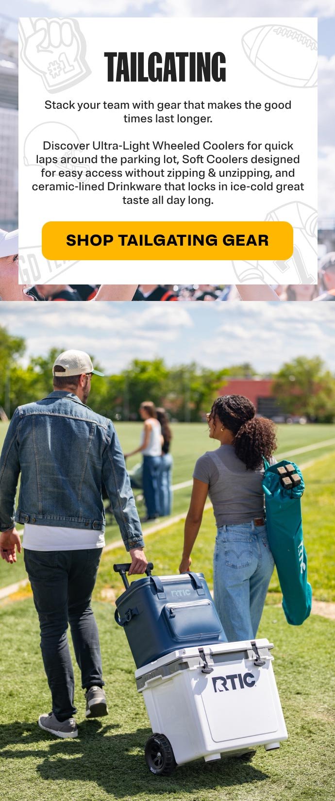Couple walking to the sports field with an RTIC wheeled hard cooler and soft cooler.