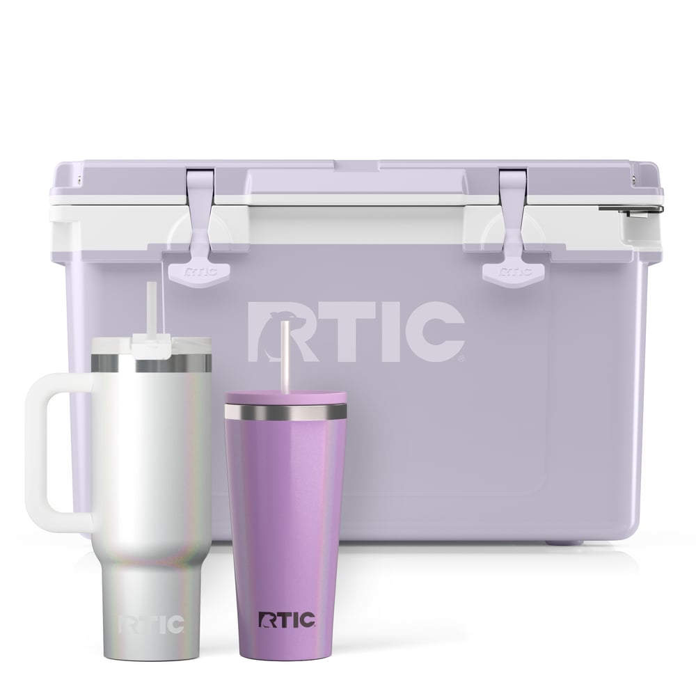Light purple RTIC hard cooler with white glitter tumbler with handle and straw and purple tumbler with straw.