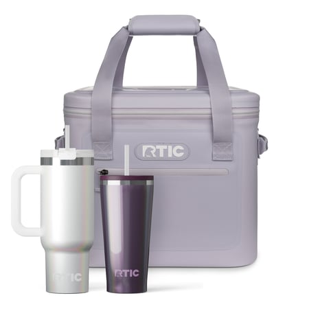 RTIC lavender soft cooler, white glitter tumbler with straw and handle, and purple glitter tumbler with straw.
