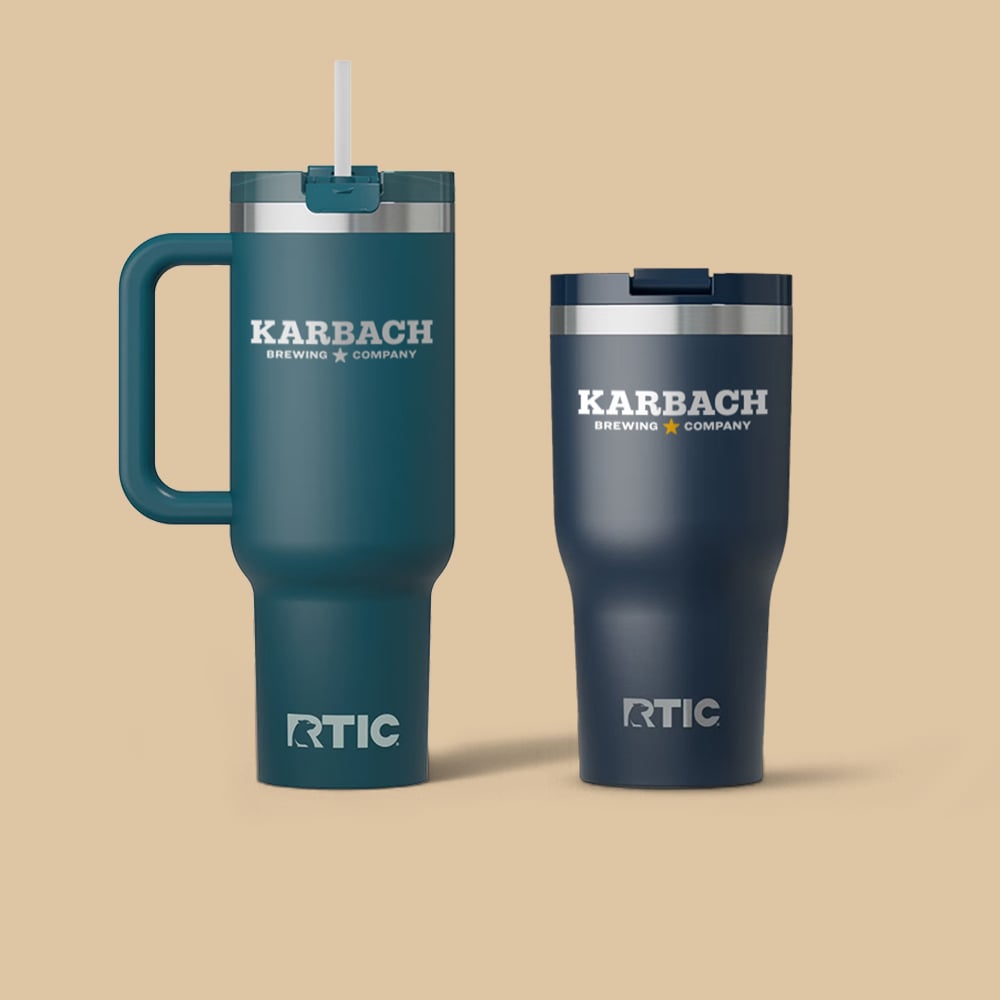 Blue Road Trip Tumbler and navy blue Essential Tumbler with customer logos printed on them.