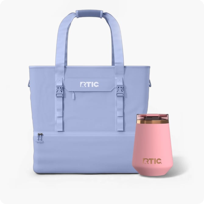 Light purple RTIC tote-style cooler bag with straps, paired with a pink insulated wine tumbler, both displayed on a neutral background.