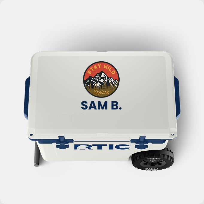 A light grey RTIC hard cooler with the name Sam and mountain design on it on a light grey background.
