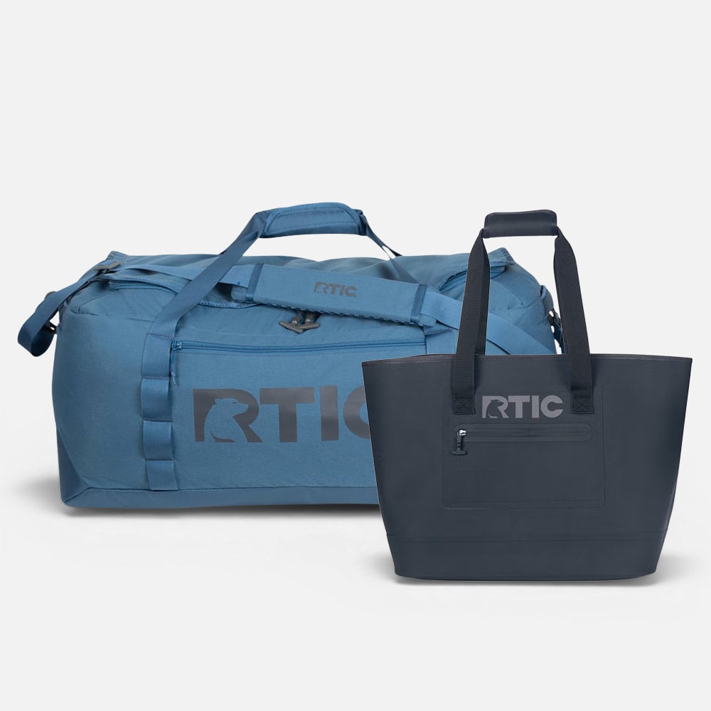 Blue RTIC duffel bag and black tote bag with zipper pockets, both rugged, waterproof-style designs.