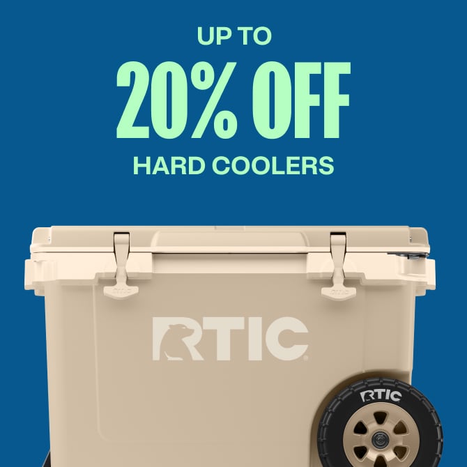 A tan RTIC hard cooler on a blue background.