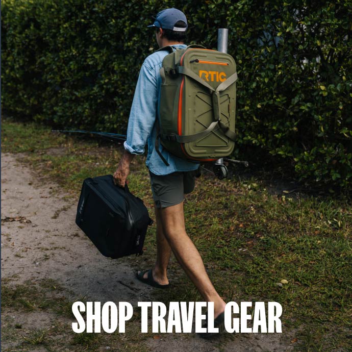 Man walking on a trail, carrying an Ultra-Dry Backpack on his back.