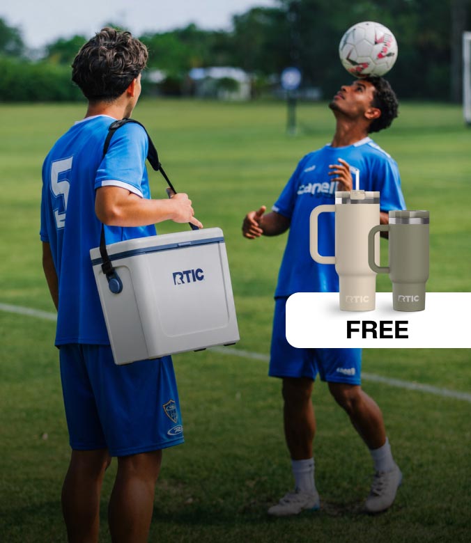 Soccer player carrying a white RTIC cooler on the field while teammates practice, with a free RTIC tumbler promotion shown.