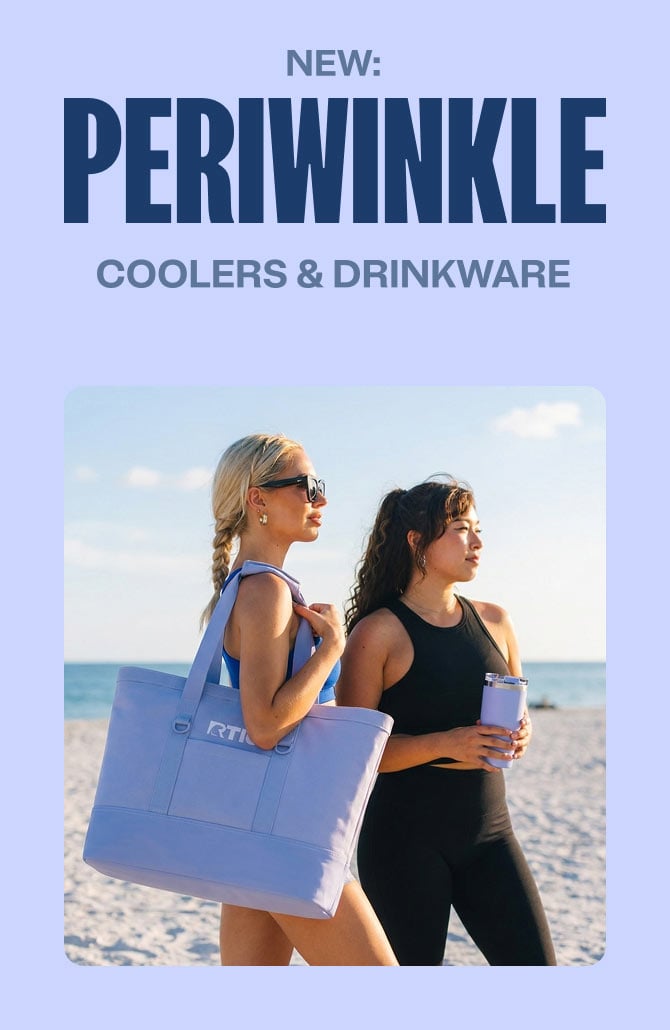 Two women in athletic wear walk along a sunny beach, carrying a pastel purple RTIC tote and a matching tumbler by the ocean.