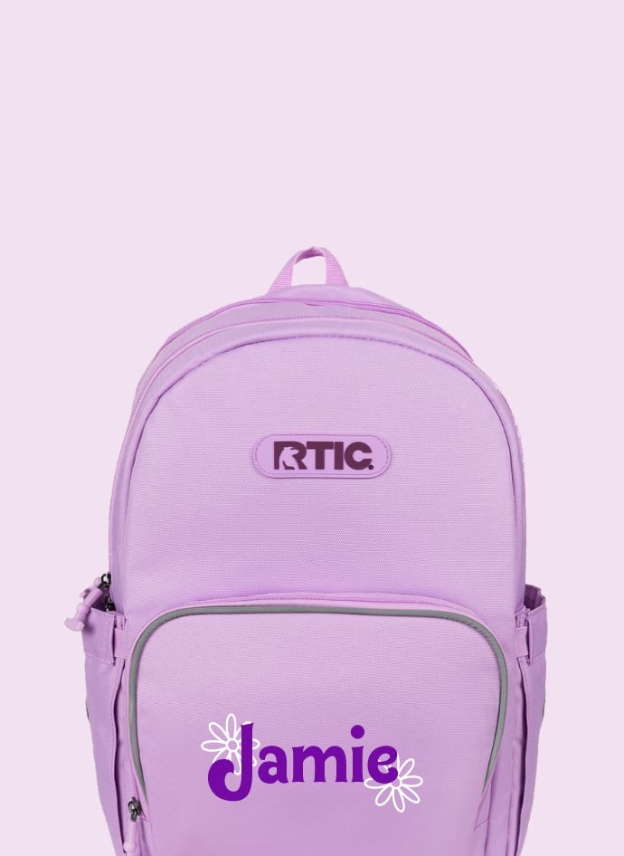 A light purple RTIC kids cooler backpack with the name Jamie on it in purple and two white flowers - on a light purple. background.