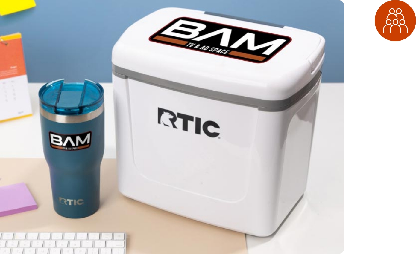 A customized RTIC Cooler and Tumbler sitting on an office desk next to a computer keyboard.